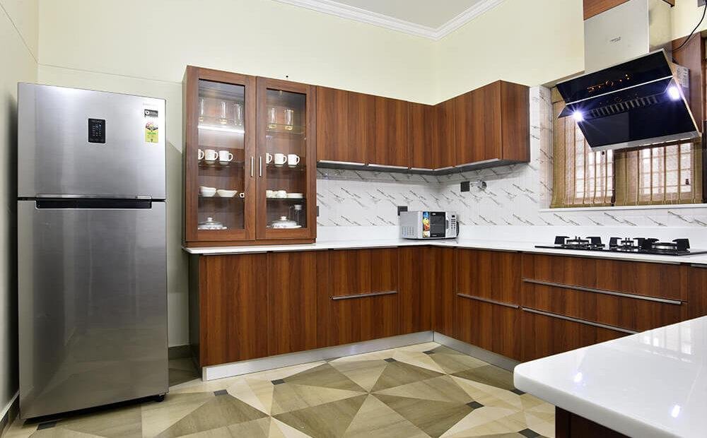 classic-wood-finish-kitchen-with-glass-cabinets-parkland-thrissur-kerala