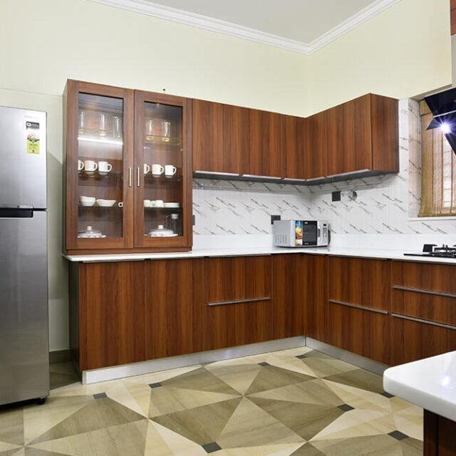 classic-wood-finish-kitchen-with-glass-cabinets-parkland-thrissur-kerala