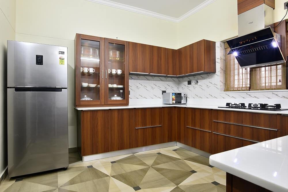 classic-wood-finish-kitchen-with-glass-cabinets-parkland-thrissur-kerala