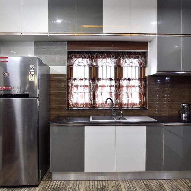 grey-white-high-gloss-kitchen-with-brown-backsplash-parkland-thrissur-kerala