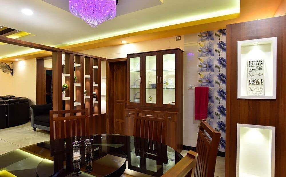 interior-designers-in-thrissur-vibrant-dining-room-with-glass-cabinet-angle1