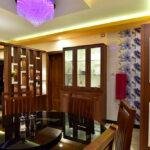 Interior designers in thrissur vibrant dining room with glass cabinet