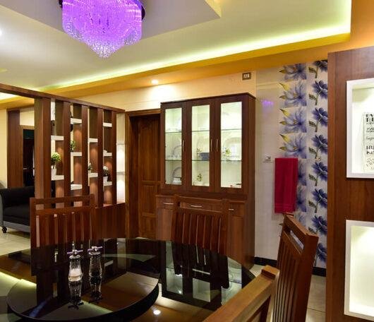 interior-designers-in-thrissur-vibrant-dining-room-with-glass-cabinet-angle1