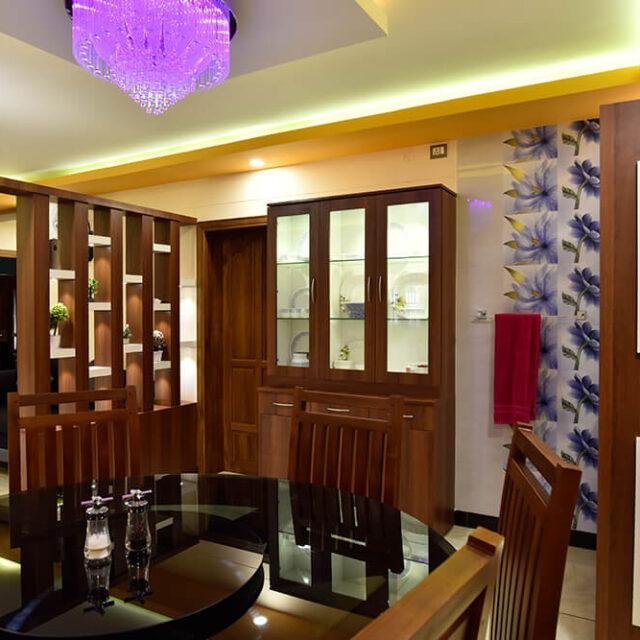 interior-designers-in-thrissur-vibrant-dining-room-with-glass-cabinet-angle1
