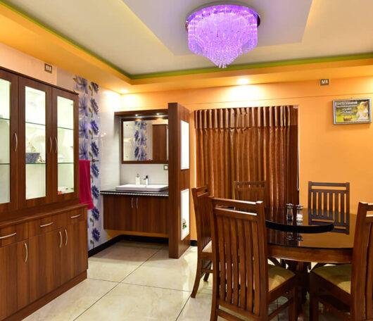 interior-designers-in-thrissur-vibrant-dining-room-with-glass-cabinet-angle2