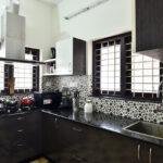Sleek dark wood kitchen with pattern tiles parkland thrissur kerala