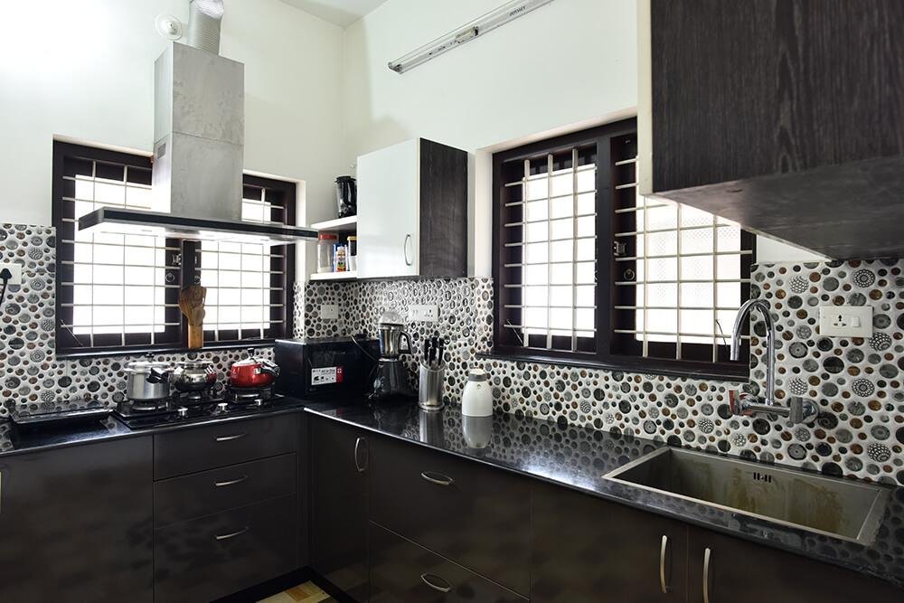 sleek-dark-wood-kitchen-with-pattern-tiles-parkland-thrissur-kerala