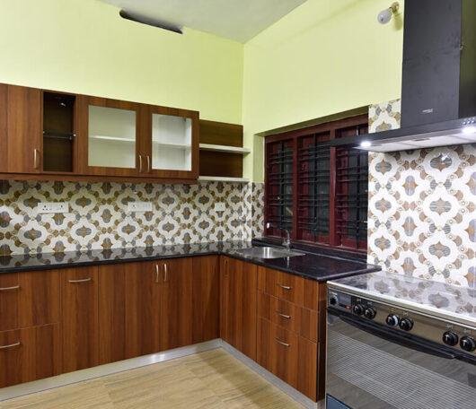 wood-finish-kitchen-with-pattern-tiles-parkland-thrissur-kerala