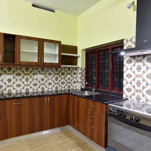 wood-finish-kitchen-with-pattern-tiles-parkland-thrissur-kerala