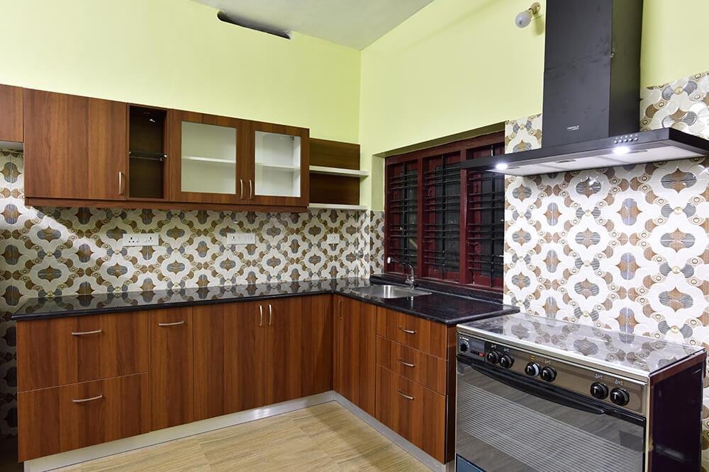 wood-finish-kitchen-with-pattern-tiles-parkland-thrissur-kerala